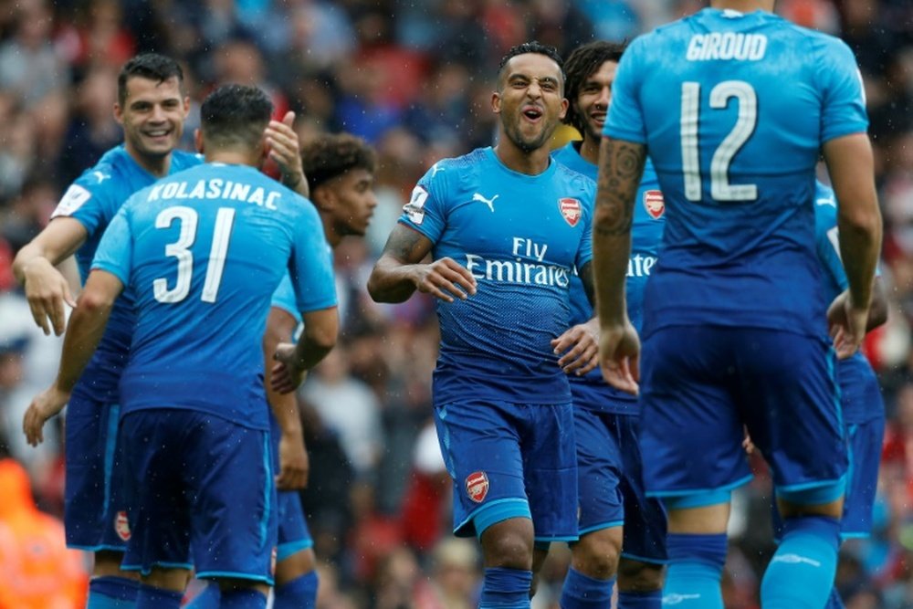 Walcott scored twice to help Arsenal beat Benfica. AFP