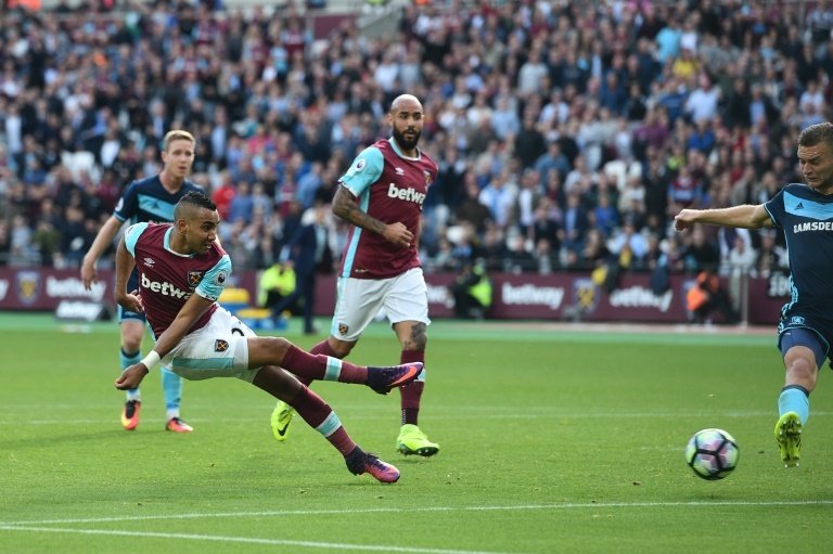 West Ham Uniteds French midfielder Dimitri Payet (L) scores to equalise 1-1 against Middlesbrough at The London Stadium, in east London on October 1, 2016