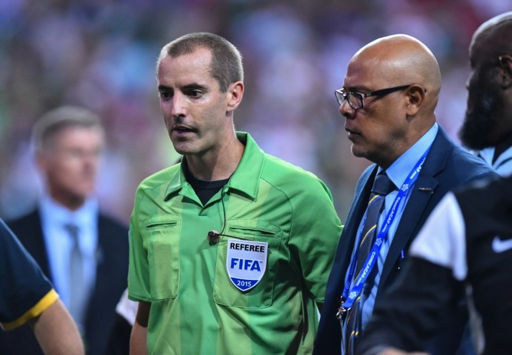 US referee Mark Geiger (L) is escorted by security off the field after a CONCACAF Gold Cup semifinal football match between Mexico and Panama in Atlanta on July 22, 2015