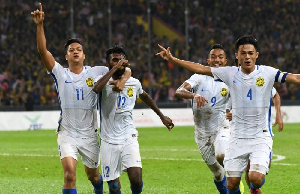 Malaysian players celebrate their goal against Indonesia. AFP