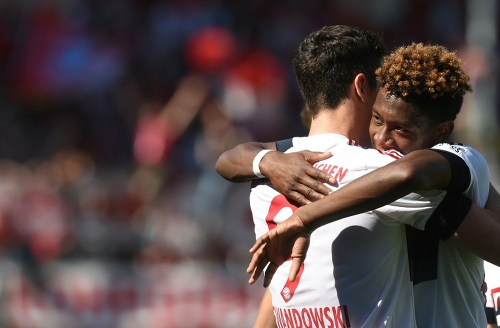 Bayern Munich defender David Alaba embraces teammate Robert Lewandowski after a goal. BeSoccer
