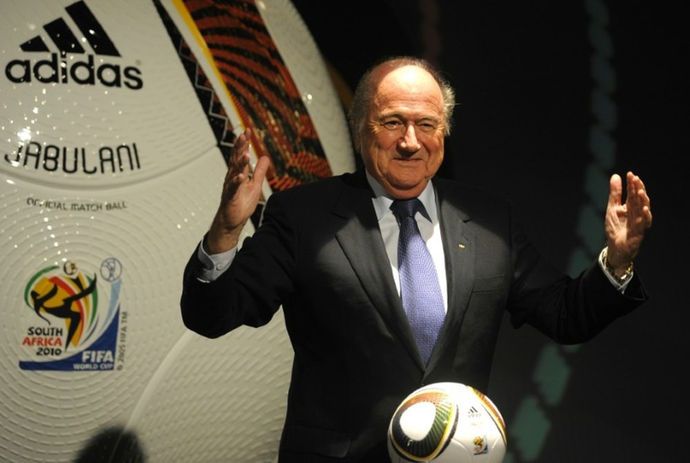 FIFA President Sepp Blatter posing with Jabulani the official Adidas match ball for the 2010 World Cup during the handover event in 2009