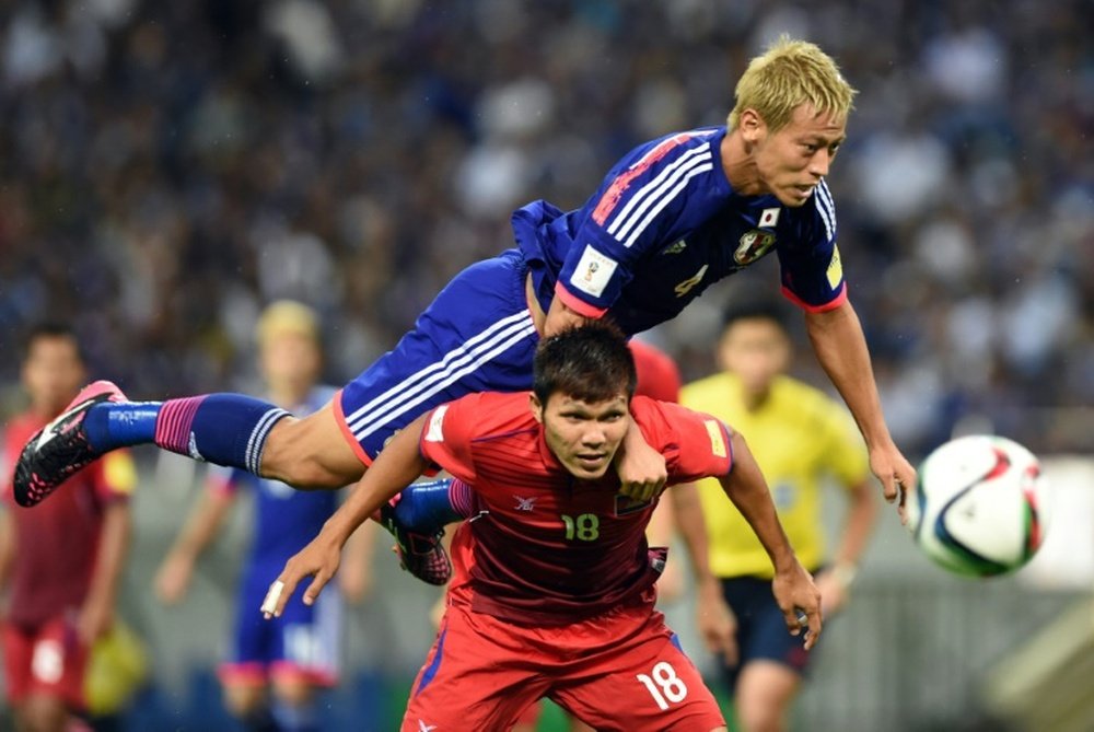 Keisuke Honda (top) scored a first half goal to help Japan towards a 3-0 win over Singapore