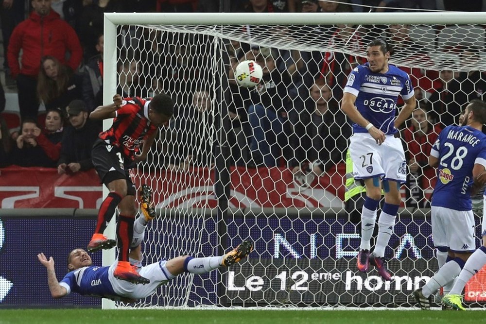 Nices forward Alassane Plea (L) scores a header during the French L1 football match between Nice and Bastia at the Allianz Riviera stadium in Nice, southeastern France, on November 27, 2016