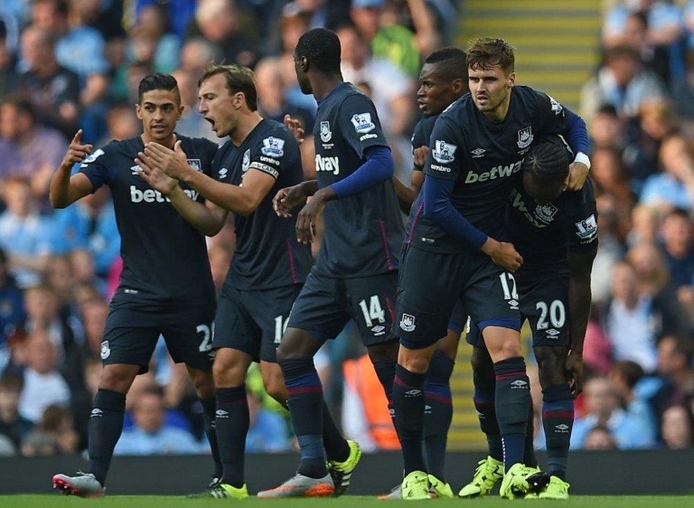 West Ham Uniteds midfielder Victor Moses (R) celebrates with teammates after scoring during an English Premier League football match against Manchester City at The Etihad Stadium in Manchester, north west England on September 19, 2015