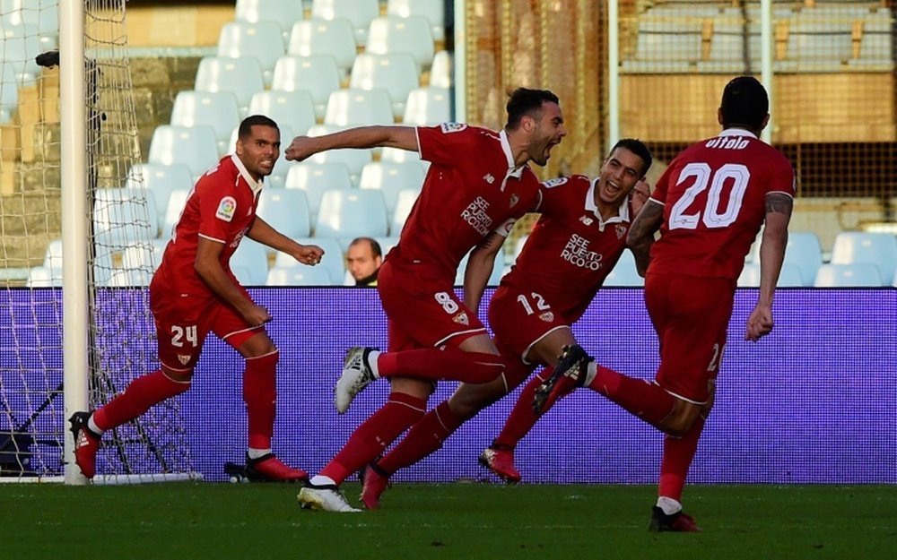 Sevillas midfielder Vicente Iborra (2ndR) celebrates with teammates after scoring. AFP