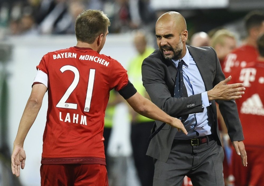 Pep Guardiola (right) talks to Philipp Lahm during the German Supercup gamne against VfL Wolfsburg in Wolfsburg on August 1, 2015