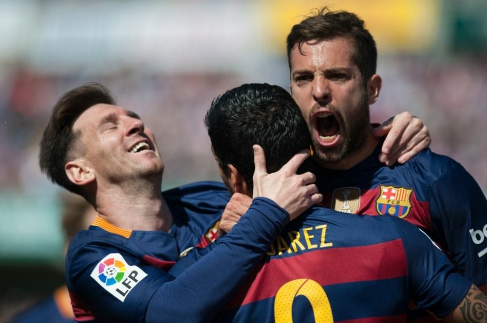 Barcelonas Luis Suarez (C), Jordi Alba (R) and Lionel Messi (L) celebrate scoring against Granada on May 14, 2016, the day they were crowned champions of this seasons Spanish League