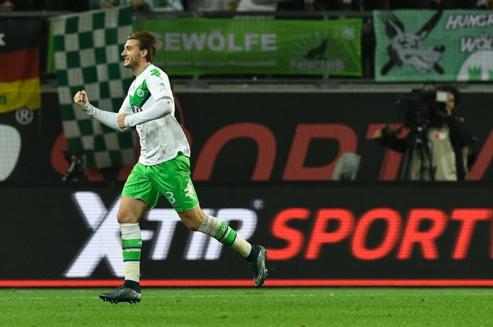 Wolfsburgs Danish forward Nicklas Bendtner celebrates after scoring during the German first division Bundesliga match against Leverkusen in Wolfsburg on October 31, 2015