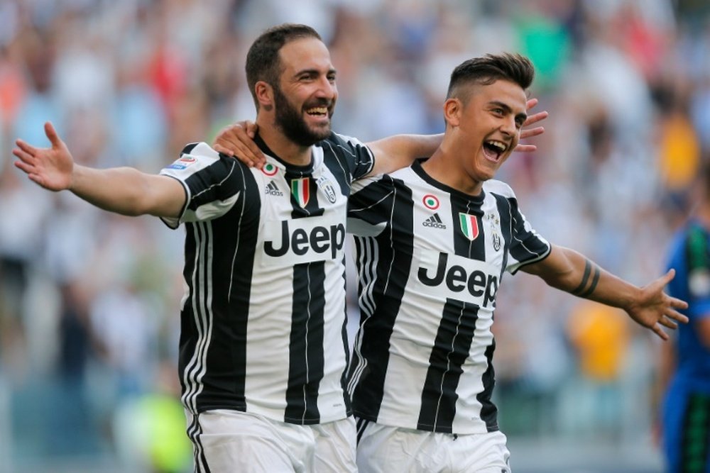Juventus Gonzalo Higuain (L) celebrates with teammate Paulo Dybala after scoring a goal on September 10, 2016 at the Juventus Stadium in Turin