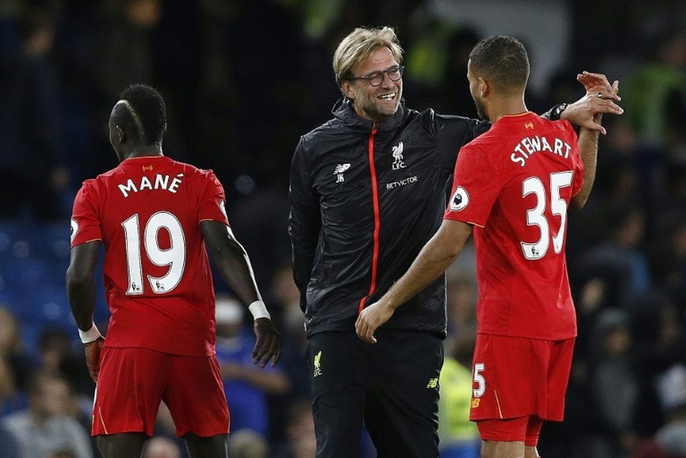 Liverpool manager Jurgen Klopp celebrates with defender Kevin Stewart. AFP