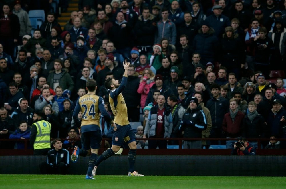 Arsenal's striker Olivier Giroud (R) celebrates scoring from the penalty spot during an English Premier League football match against Aston Villa on December 13, 2015