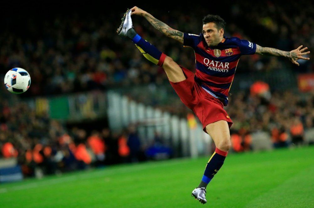 Barcelonas Brazilian defender Dani Alves jumps for the ball during the Spanish Copa del Rey (Kings Cup) round of 16 first leg football match FC Barcelona vs RCD Espanyol at the Camp Nou stadium in Barcelona