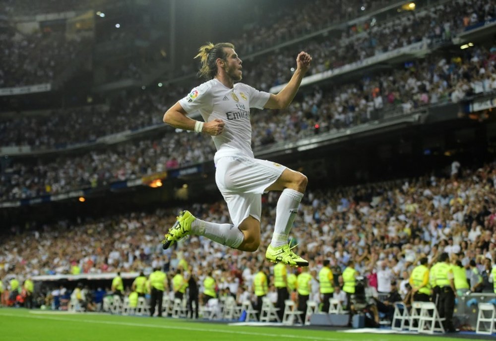 Real Madrids Welsh forward Gareth Bale celebrates after scoring his second goal during the Spanish league football match Real Madrid CF vs Real Betis Balompie at the Santiago Bernabeu stadium in Madrid on August 29, 2015