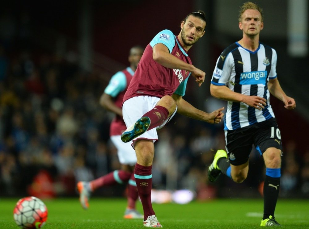 Newcastle Uniteds Dutch midfielder Siem de Jong watches as West Ham Uniteds English striker Andy Carroll (left) passes the ball during their English Premier League match at The Boleyn Ground in Upton Park, East London on September 14, 2015