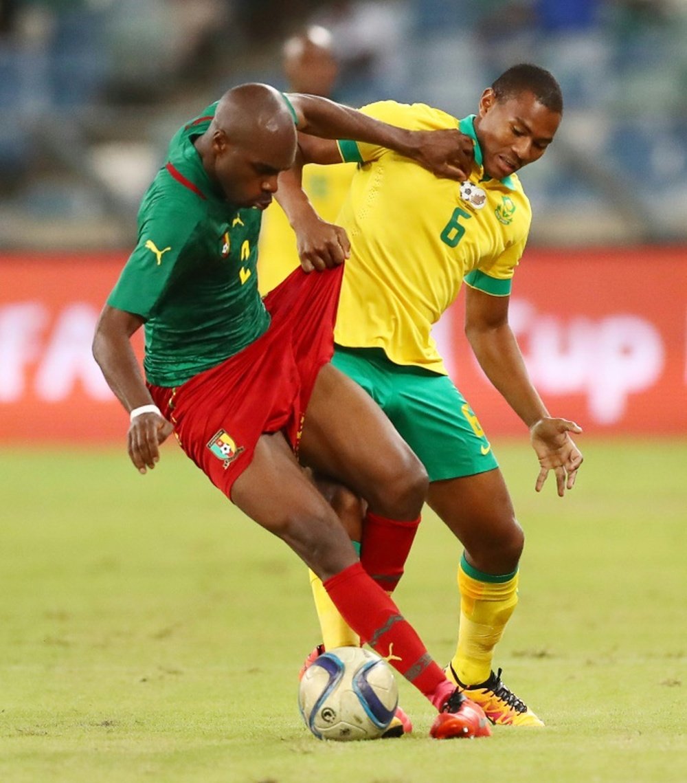 South Africa's Prince Nxumalo (R) tackles Cameroons's Allan Romeo Nyom (L) during the African Cup of Nations 2017 qualifier match at the Moses Mabhida stadium on March 29, 2016