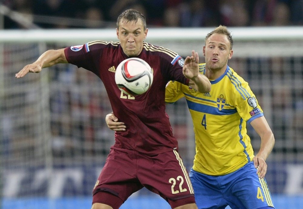 Russia's forward Artem Dzyuba (L) fights for the ball with Sweden's defender Andreas Granqvist during a Euro 2016 qualifying match in Moscow on September 5, 2015