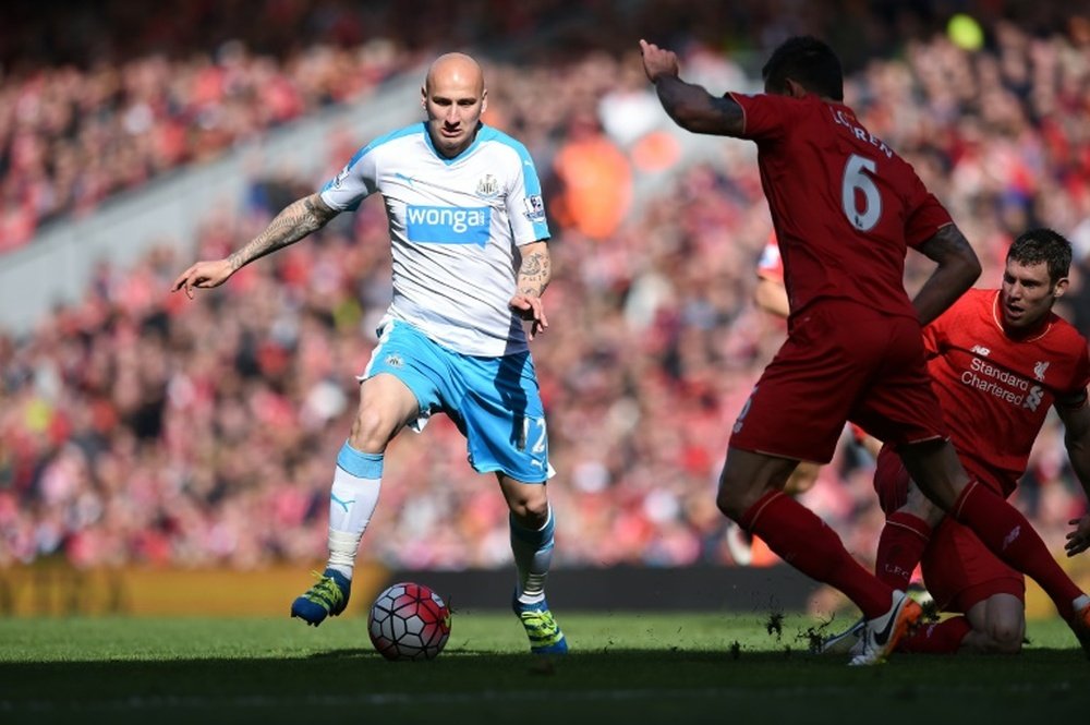 Jonjo Shelvey (L) runs with the ball against Liverpool last season. AFP