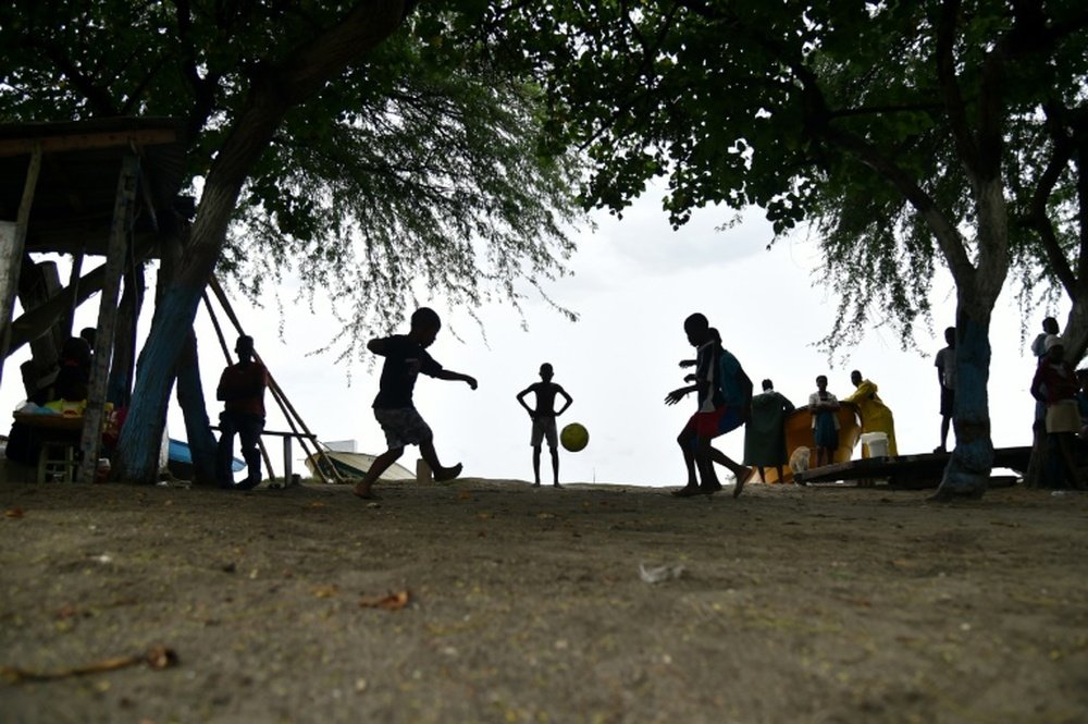 Children play football close to Caira beach in the commune of Leogane, south-west of Port-au-Prince