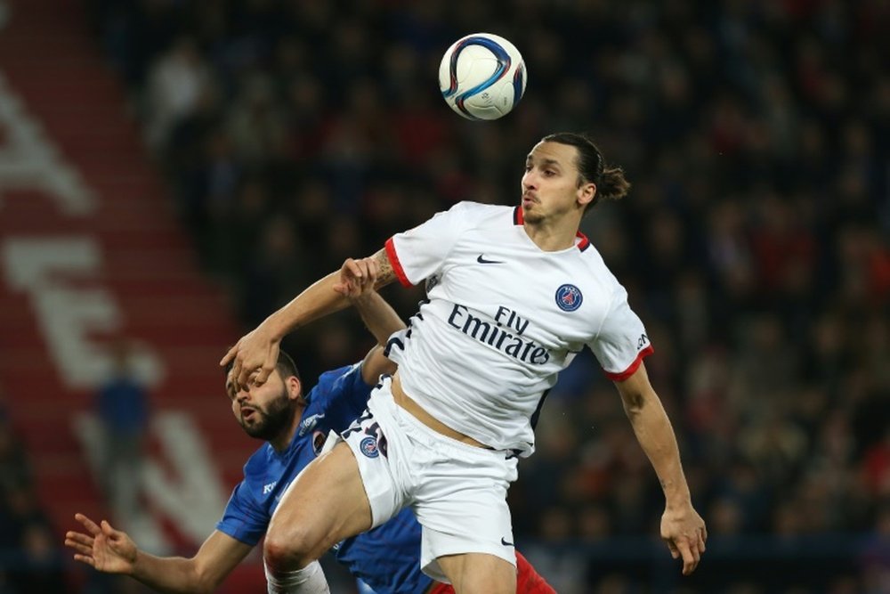 Caens defender Syam Ben Youssef (L) vies with Paris Saint-Germains forward Zlatan Ibrahimovic during the French L1 football match on December 19, 2015 at the Michel dOrnano stadium, in Caen, France