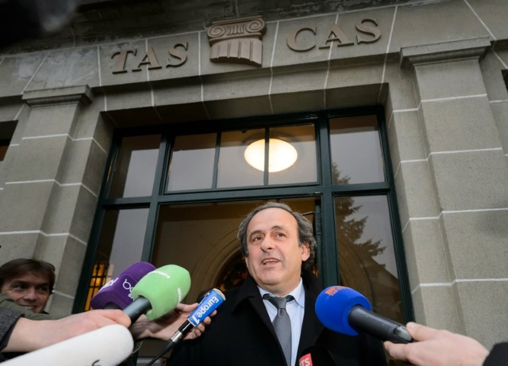UEFA president Michel Platini answering journalists questions as he leaves the Court of Arbitration for Sport (CAS) after an hearing for an appeal against a 90-day suspension in Lausanne on December 8, 2015