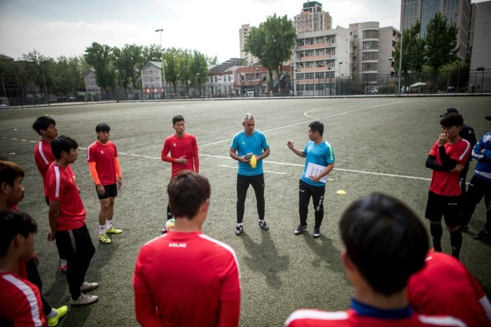 Beijing Institute of Technologys Spanish head coach Roberto Ahufinger del Pino instructs players