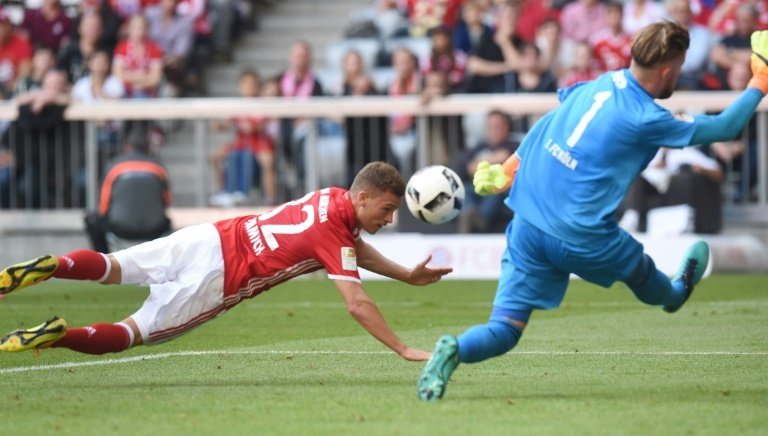Bayern Munichs midfielder Joshua Kimmich (L) heads the first goal for Munich against Colognes goalkeeper Timo Horn (R) during the German first division Bundesliga football match between FC Bayern Munich and 1 FC Cologne