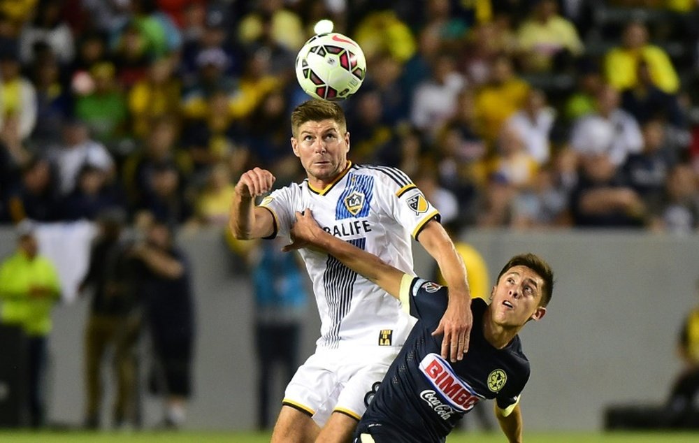 Gerrard (L) is expected to turn down the MK Dons job. AFP