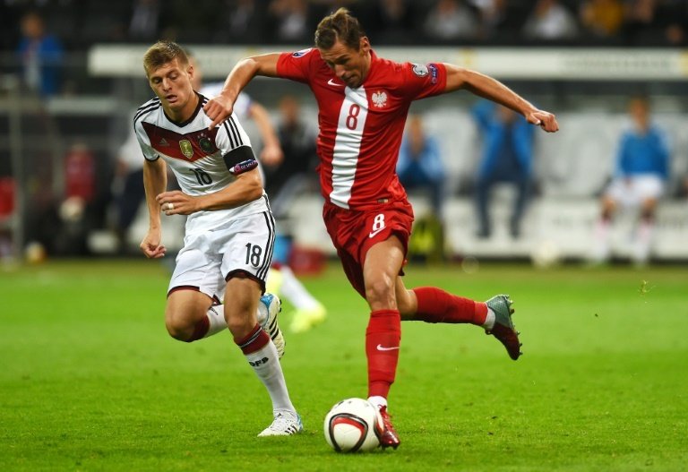 Polands Grzegorz Krychowiak and Germanys midfielder Toni Kroos vie for the ball during their Euro 2016 qualifying match in Frankfurt am Main, Germany, on September 4, 2015