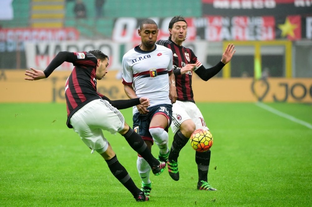 AC Milans defender from Italy Mattia De Sciglio (left) fights for the ball with Genoas defender from Brazil Gabriel Silva during their Italian Serie A match at the San Siro Stadium stadium in Milan on February 14, 2016