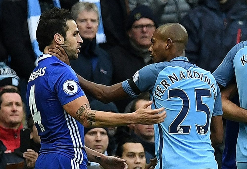 Fernandinho (R) was sent off for an altercation with Cesc Fabregas. AFP