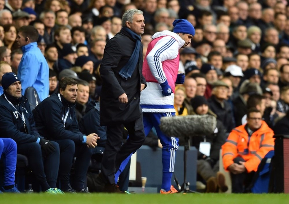 Chelseas Diego Costa (R) passes manager Jose Mourinho during the English Premier League football match against Tottenham Hotspur, at White Hart Lane in London, on November 29, 2015