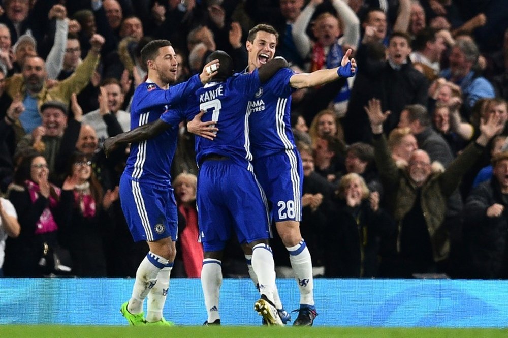 Chelseas midfielder NGolo Kante (C) celebrates with Eden Hazard. AFP