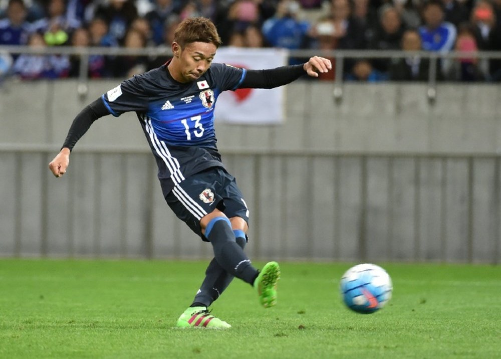 Japans Hiroshi Kiyotake puts Japan ahead from the penalty spot in their World Cup qualifier against Saudi Arabia in Saitama on November 15, 2016