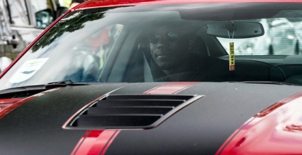 French footballer Paul Pogba arrives in a convoy of vehicles at Manchester Uniteds Carrington training complex on August 8, 2016