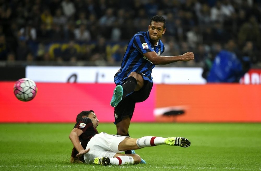 Inter Milans midfielder Fredy Guarin scores a goal during a Serie A football match against AC Milan at the San Siro Stadium in Milan on September 13, 2015