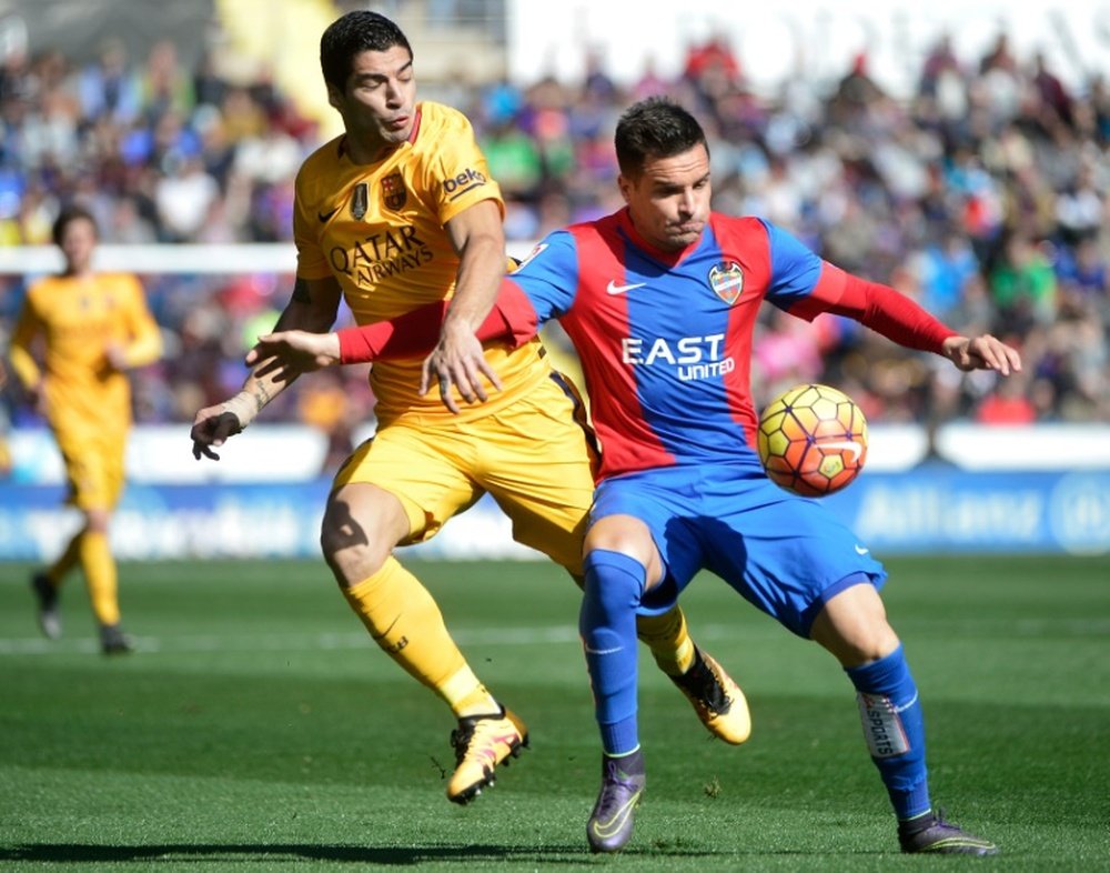 Luis Suarez (left) challengesLevantes Tono Garcia at the Ciutat de Valencia stadium on February 7, 2016