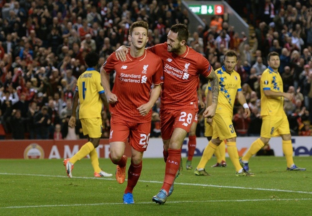 Liverpools midfielder Adam Lallana (L) celebrates with striker Danny Ings after scoring the opening goal of a UEFA Europa League group B football match against FC Sion at Anfield in Liverpool, north west England on October 1, 2015