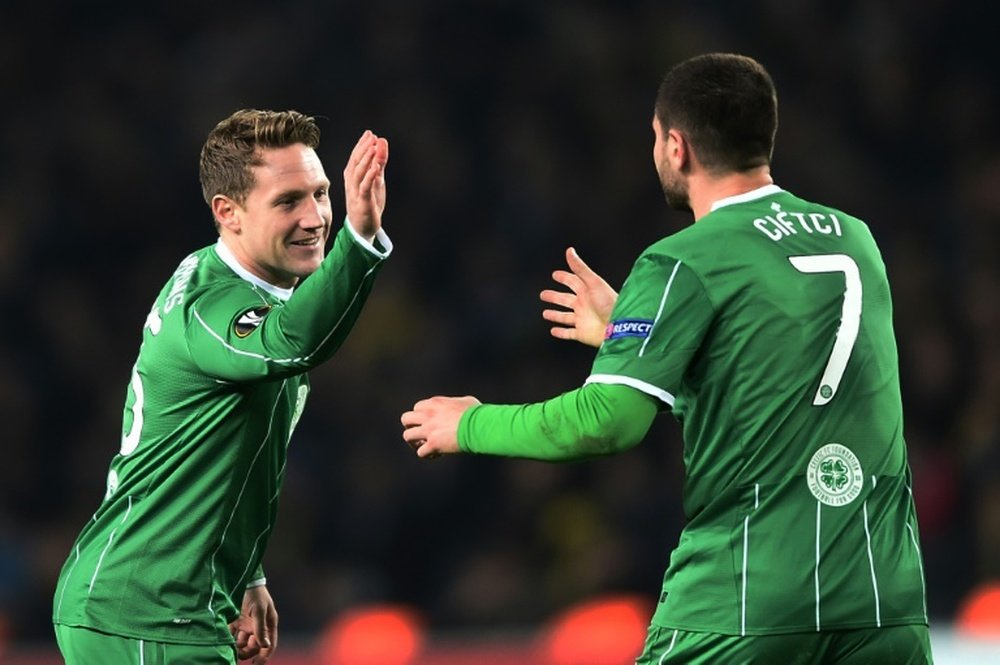 Celtics Kris Commons (L) celebrates with Nadir Ciftci after scoring during the UEFA Europa League football match between Fenerbahce and Celtic in Istanbul on December 10, 2015