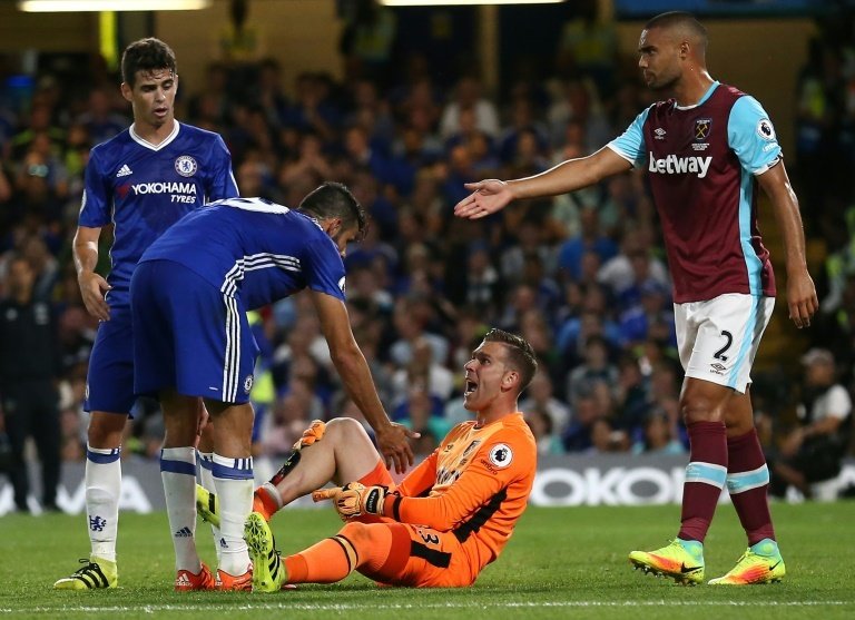 Chelseas Diego Costa (2nd L) clashes with West Ham Uniteds goalkeeper Adrian during their English Premier League match, at Stamford Bridge in London, on August 15, 2016