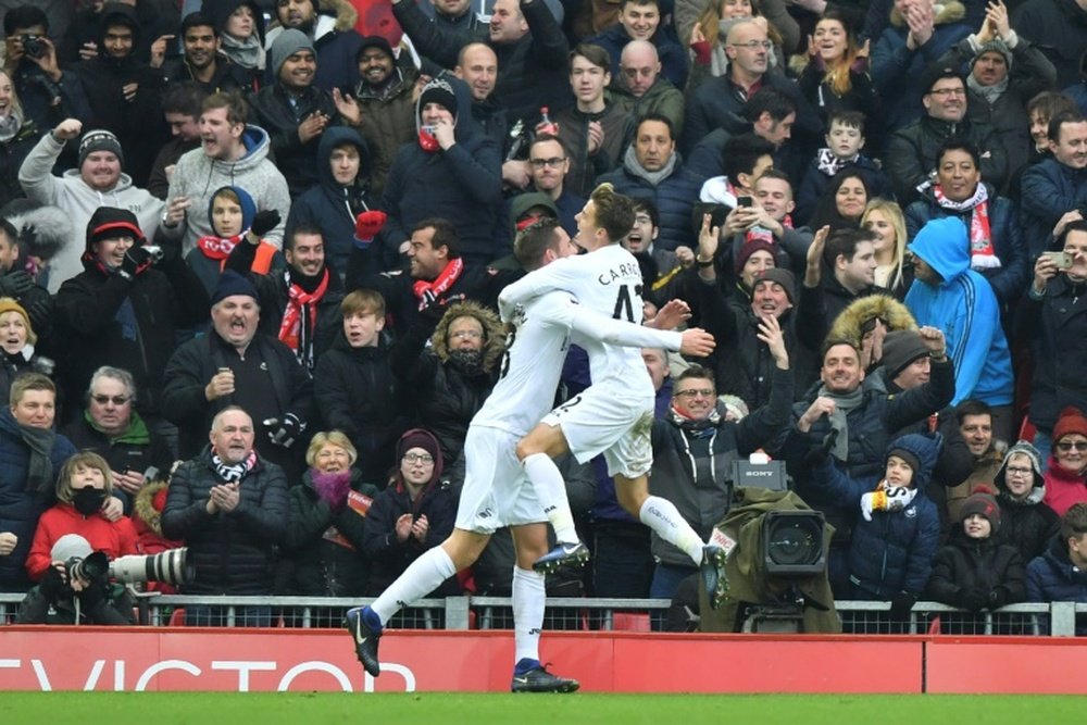 Tom Carroll jumps into the arms of Gylfi Sigurdsson