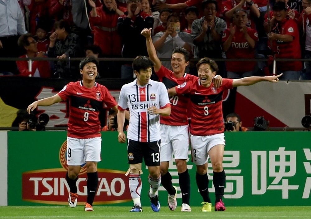 Tomoya Ugajin (R) celebrates scoring against FC Seoul in the AFC Champions League on May 18, 2016