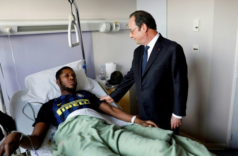 French President Francois Hollande visiting the victim, identified only as Theo. AFP