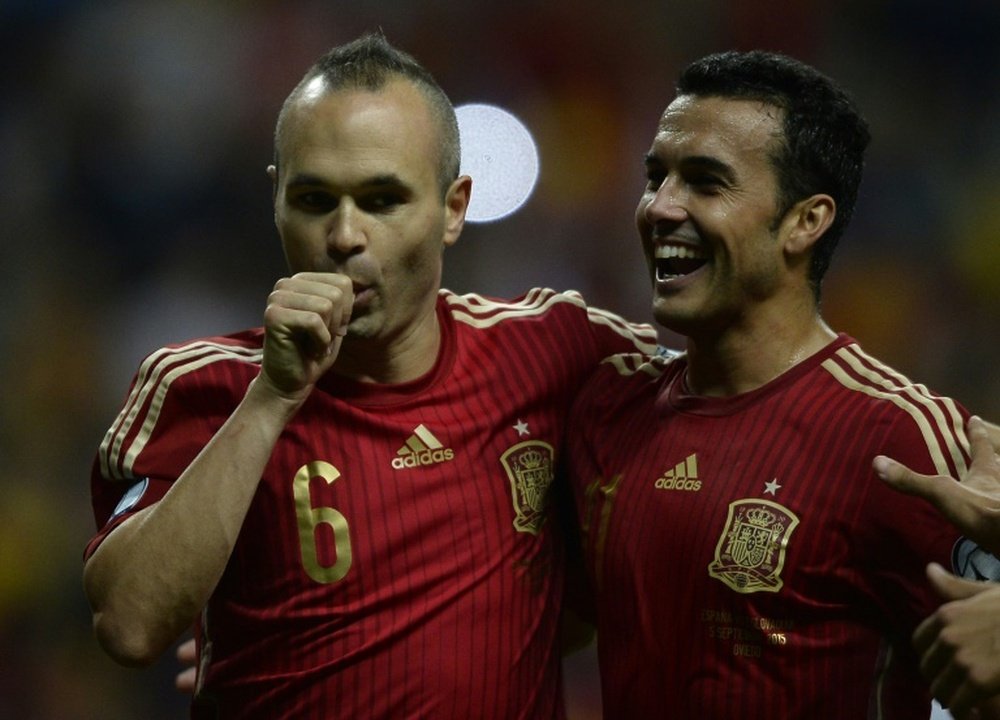 Spain midfielder Andres Iniesta (L) celebrates with forward Pedro Rodriguez after scoring during the Euro 2016 qualifier against Slovakia at the Carlos Tartiere stadium in Oviedo on September 5, 2015