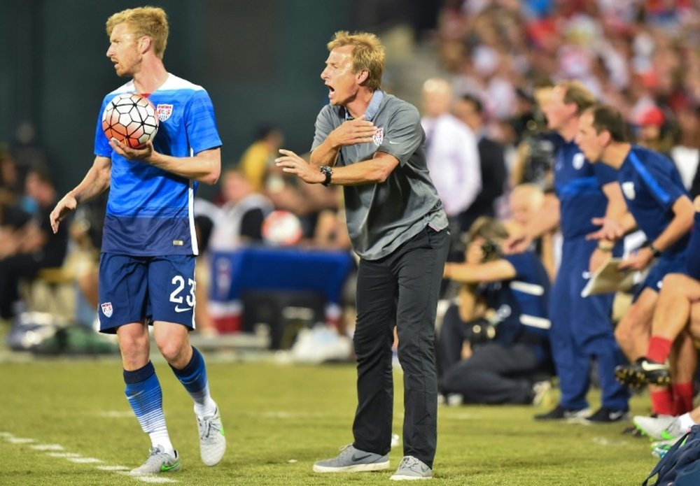 US national team coach Juergen Klinsmann (C) gives instructions to his players as Tim Ream prepares for a throw-in during an international friendly football match against Peru in Washington, DC, on September 4, 2015