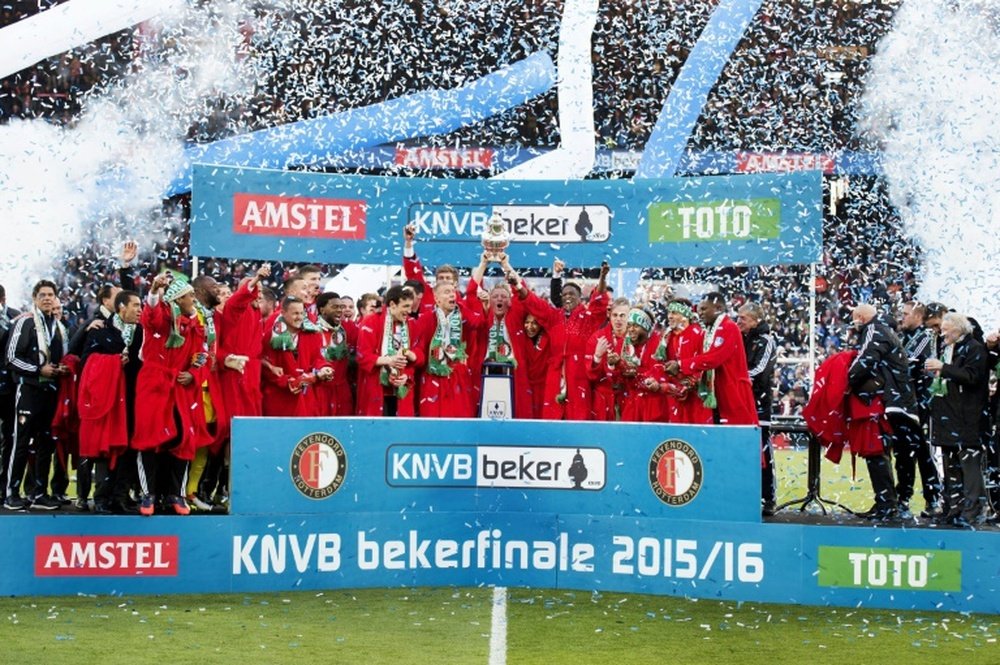 Feyenoord Rotterdams players celebrate with the trophy on the podium after winning the Dutch cup final football match against FC Utrecht, on April 24, 2016