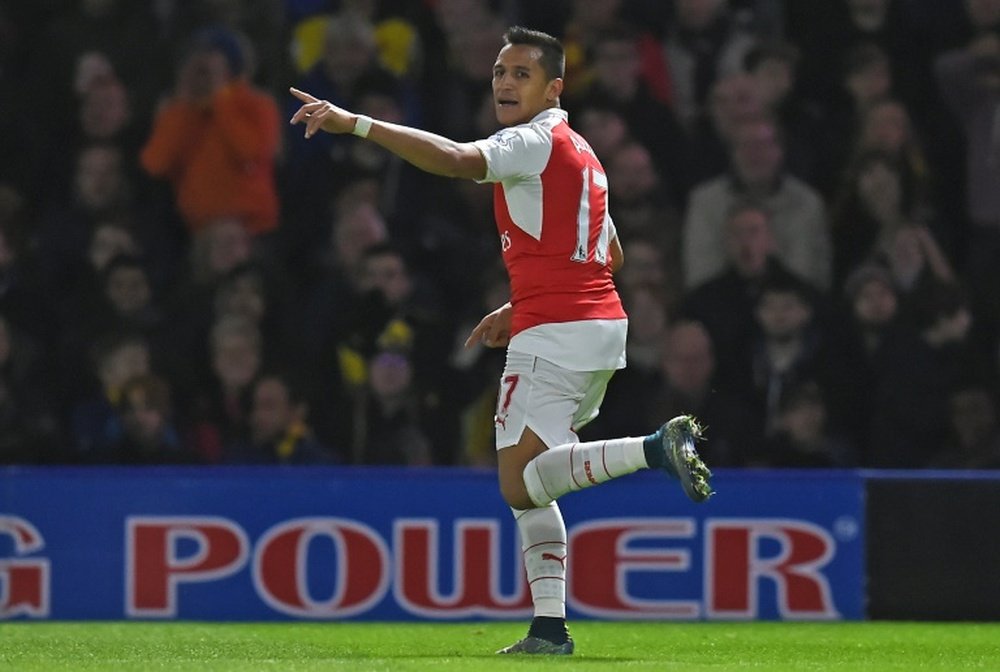 Arsenals striker Alexis Sanchez celebrates after scoring the opening goal of the English Premier League football match between Watford and Arsenal in Watford, north of London on October 17, 2015