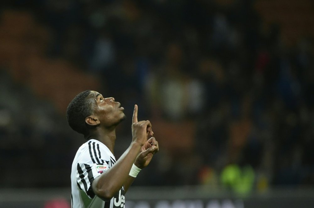 Juventus midfielder from France Paul Pogba celebrates after the Italian Serie A football match AC Milan vs Juventus on April 9, 2016 at the San Siro Stadium stadium in Milan