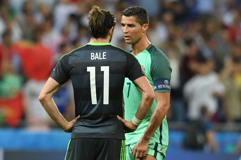 Portugal forward Cristiano Ronaldo (R) comforts Wales forward Gareth Bale at the end of the Euro 2016 semi-final on July 6, 2016