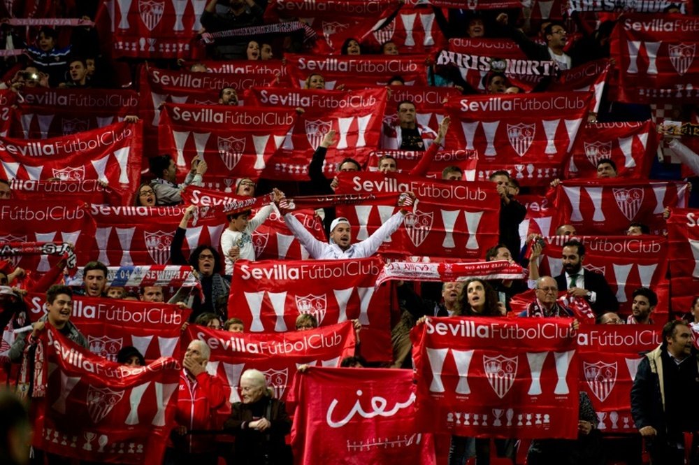 Sevillas supporters wave club standards before the UEFA Champions League football match Sevilla FC vs Manchester City in Sevilla on November 3, 2015